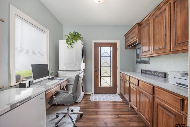 office space with stacked washer / drying machine and dark hardwood / wood-style floors