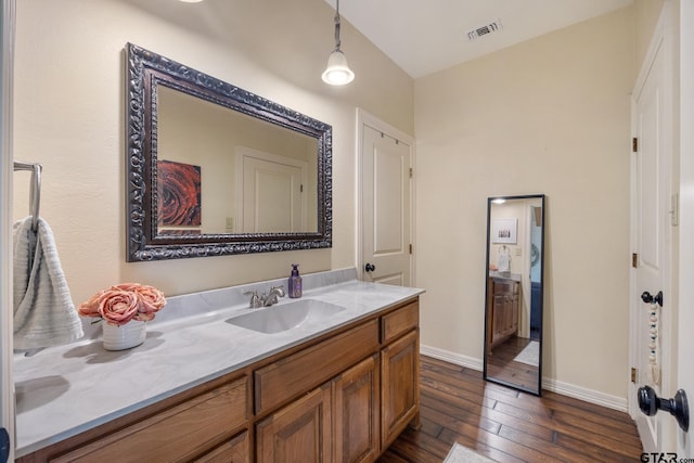 bathroom with vanity and hardwood / wood-style floors