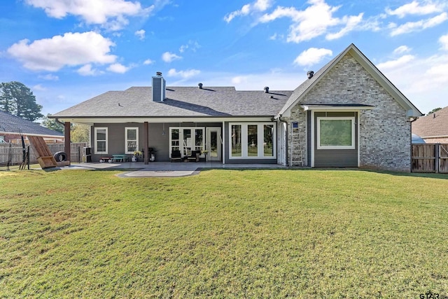 back of house with a yard, a patio, and french doors