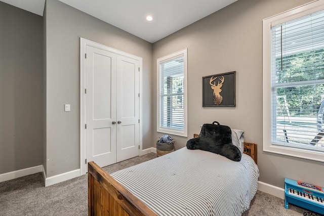 bedroom featuring a closet and light colored carpet