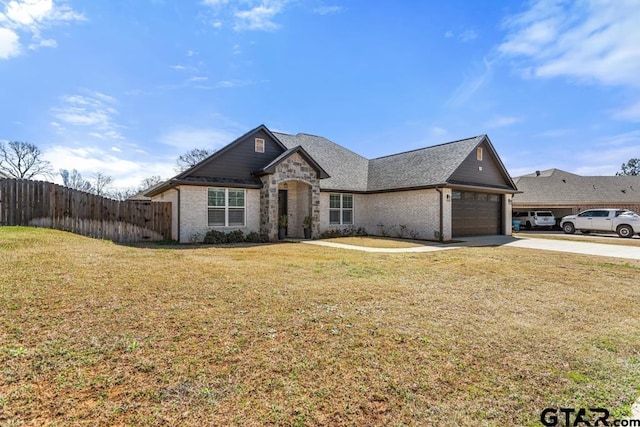 french country inspired facade featuring driveway, stone siding, fence, a front yard, and a garage