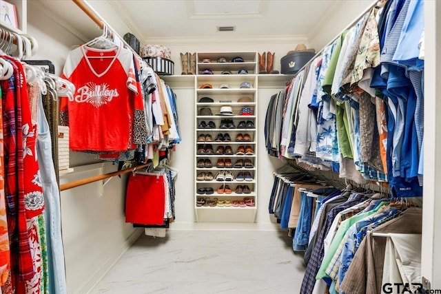 909 Univerity Dr, Carthage, TX 75633 - spacious closet featuring attic access and marble look tile flooring