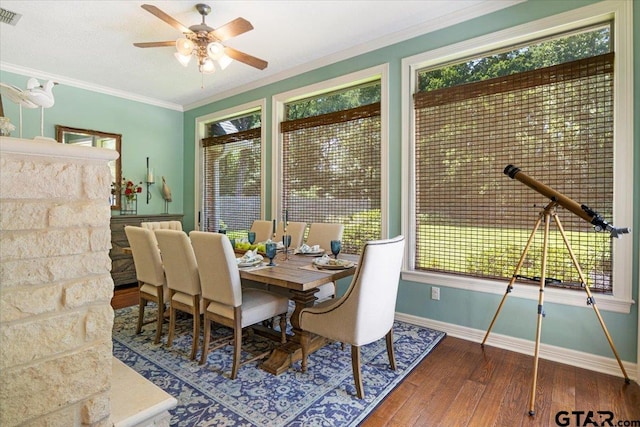 909 Univerity Dr, Carthage, TX 75633 - dining area featuring hardwood / wood-style flooring, baseboards, ceiling fan, healthy amount of natural light, and crown molding