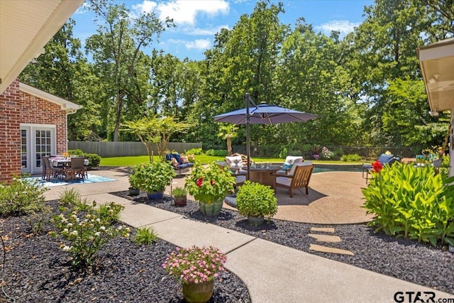 909 Univerity Dr, Carthage, TX 75633 - fenced backyard with a patio and an outdoor living space