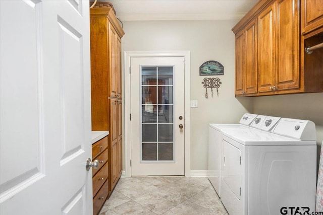 909 Univerity Dr, Carthage, TX 75633 - laundry area with cabinet space, washing machine and dryer, baseboards, and light tile patterned floors