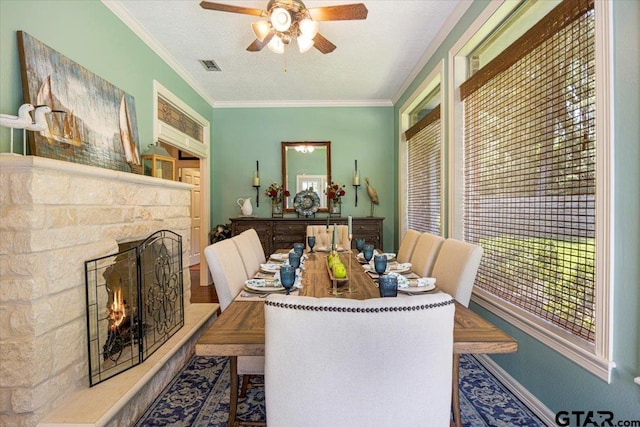 909 Univerity Dr, Carthage, TX 75633 - dining space featuring a ceiling fan, crown molding, a fireplace, and baseboards