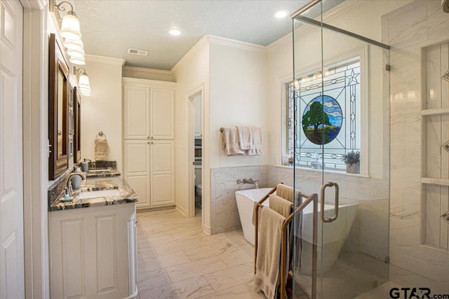 909 Univerity Dr, Carthage, TX 75633 - bathroom featuring marble finish flooring, double vanity, a freestanding tub, a stall shower, and crown molding