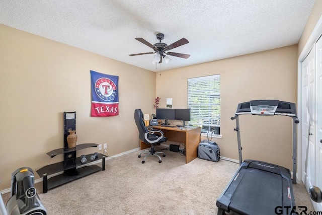 carpeted office with ceiling fan and a textured ceiling