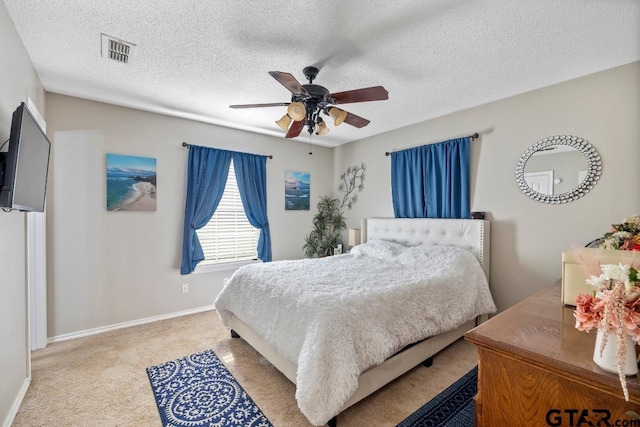 bedroom with carpet flooring, ceiling fan, and a textured ceiling