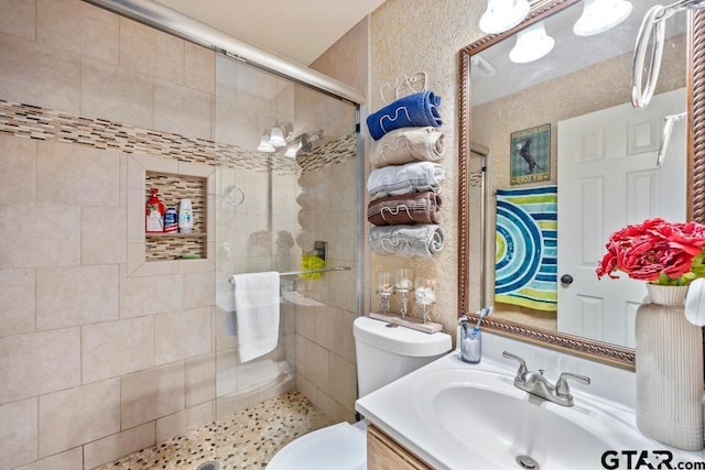 bathroom with vanity, toilet, and an enclosed shower