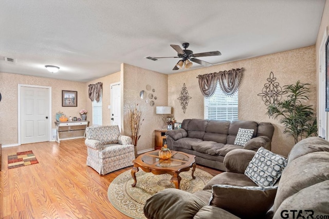 living room featuring light hardwood / wood-style floors and ceiling fan