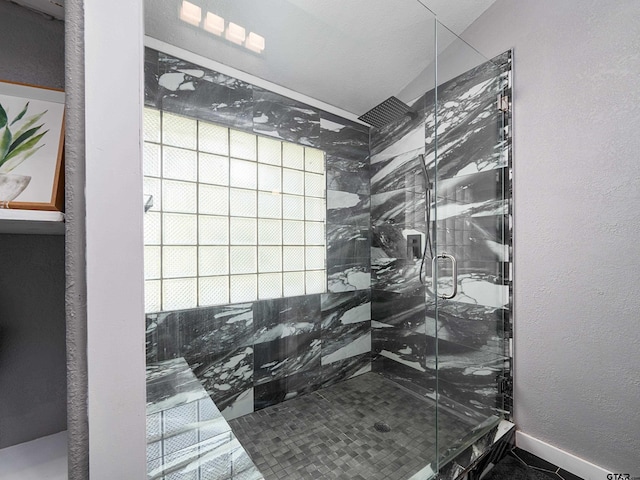 bathroom featuring a shower with shower door