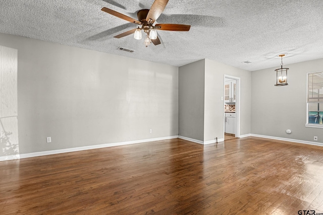 empty room featuring a textured ceiling, ceiling fan with notable chandelier, and hardwood / wood-style floors