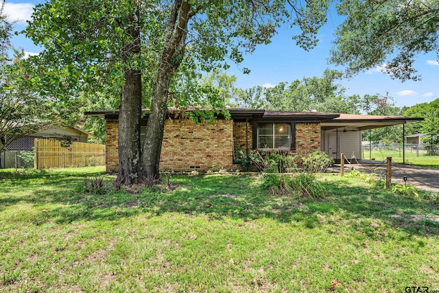 ranch-style home with a front yard and a carport