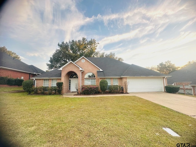 single story home featuring a garage and a front yard