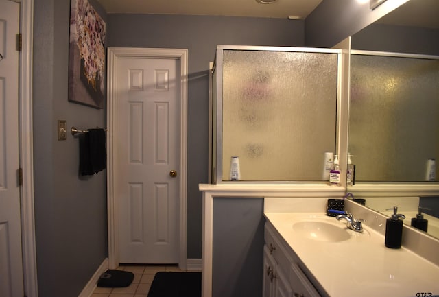 bathroom with tile patterned flooring, vanity, and a shower with shower door