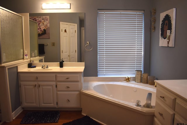 bathroom with hardwood / wood-style floors, shower with separate bathtub, and vanity