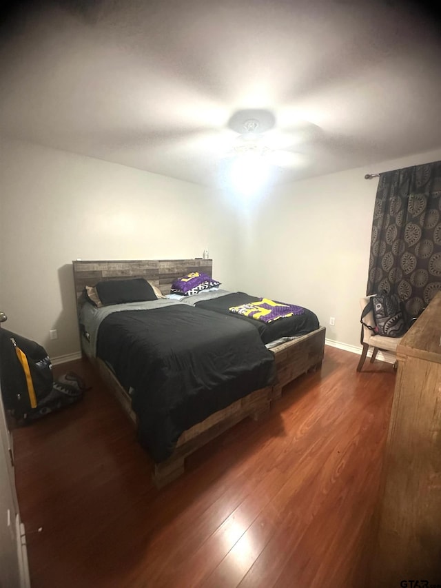 bedroom featuring dark hardwood / wood-style flooring and ceiling fan