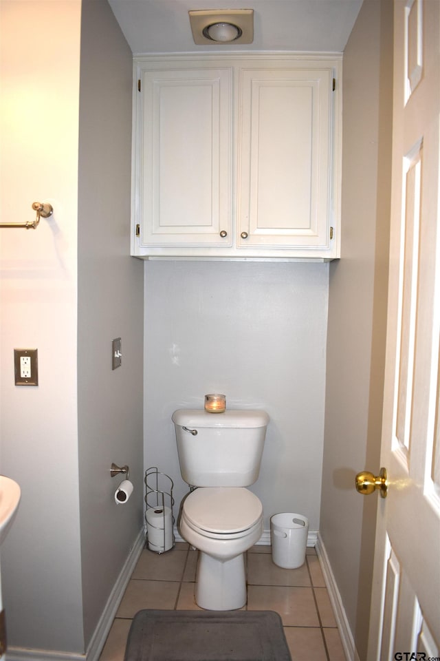 bathroom with tile patterned flooring and toilet