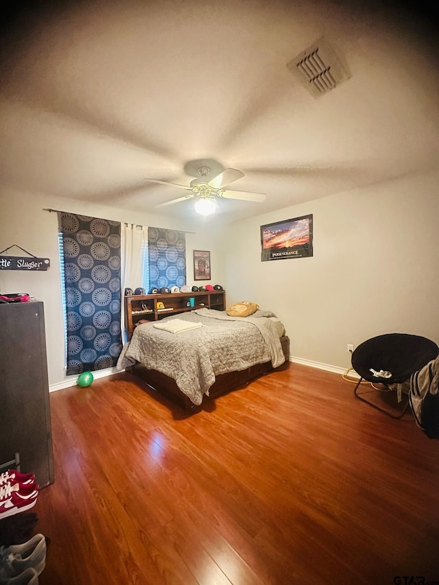 bedroom featuring hardwood / wood-style floors and ceiling fan