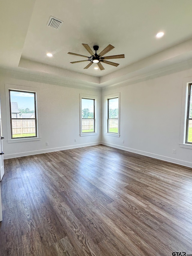 12301 Harlon, Flint, TX 75762 - spare room with a tray ceiling, healthy amount of natural light, dark wood-style flooring, and recessed lighting