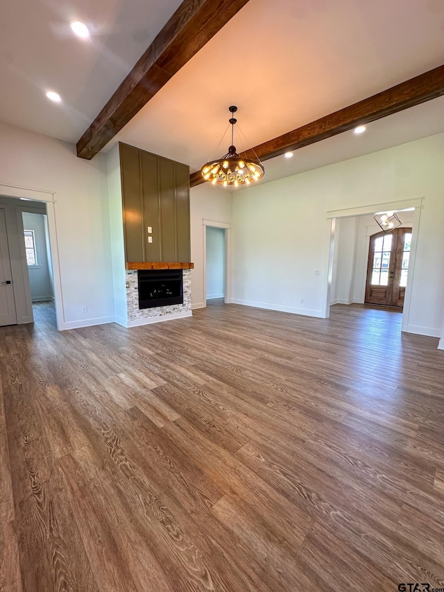 12301 Harlon, Flint, TX 75762 - unfurnished living room with a chandelier, beam ceiling, dark wood-type flooring, a fireplace, and recessed lighting