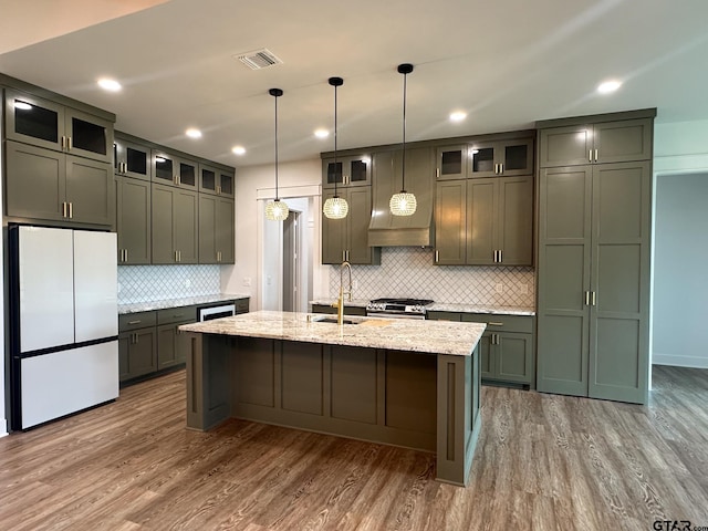 12301 Harlon, Flint, TX 75762 - kitchen with freestanding refrigerator, dark wood-style flooring, light stone counters, decorative backsplash, and recessed lighting
