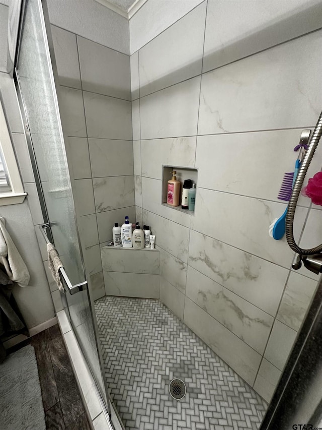 bathroom featuring a shower with door