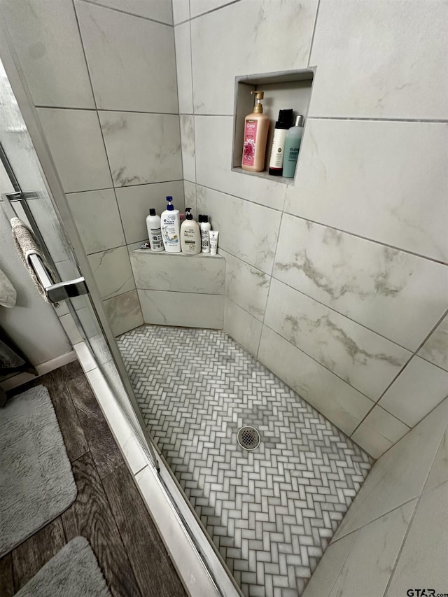 bathroom featuring a shower and hardwood / wood-style floors