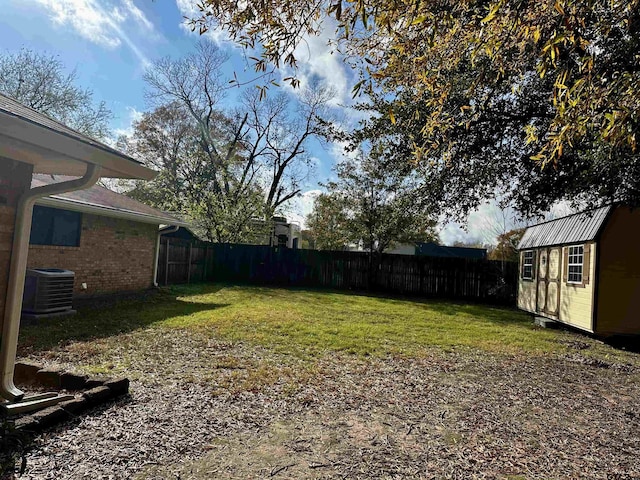 view of yard with a shed and central AC unit