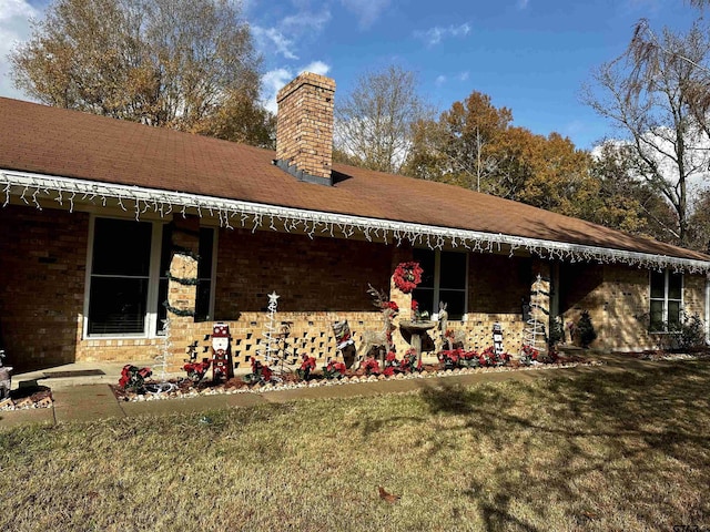 rear view of property featuring a yard