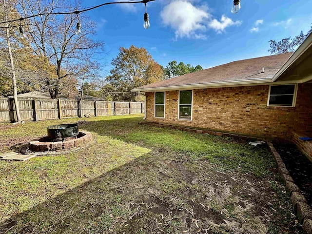 view of yard featuring an outdoor fire pit