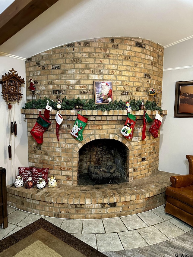 living room with a brick fireplace and lofted ceiling