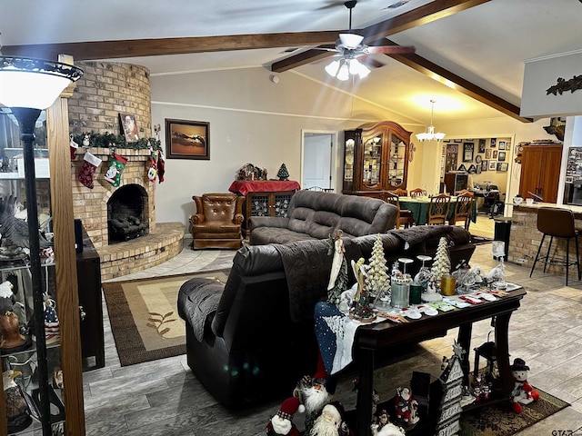 living room featuring ceiling fan with notable chandelier, vaulted ceiling with beams, hardwood / wood-style flooring, and a brick fireplace