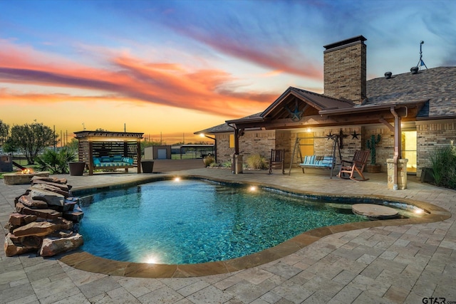 pool at dusk featuring a patio area