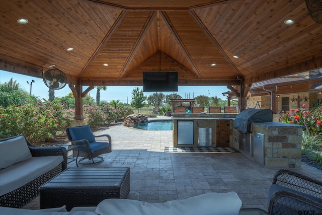 view of patio featuring an outdoor living space, an outdoor kitchen, a gazebo, and grilling area