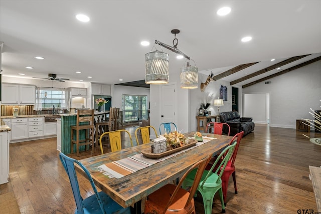 dining room with ceiling fan, vaulted ceiling with beams, and dark hardwood / wood-style floors