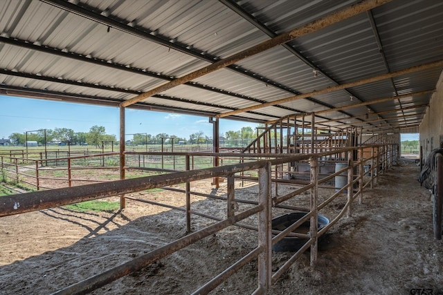 view of horse barn featuring a rural view