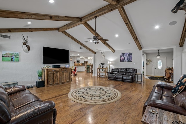 living room featuring hardwood / wood-style flooring, ceiling fan, beam ceiling, and high vaulted ceiling