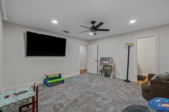 recreation room with ceiling fan and carpet floors