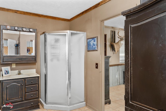 bathroom featuring tile patterned flooring, vanity, ornamental molding, and a shower with shower door