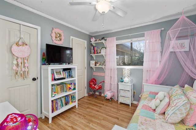 bedroom featuring ceiling fan, ornamental molding, and wood-type flooring