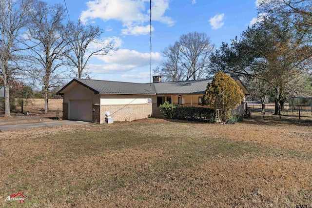 exterior space featuring a garage and a front yard