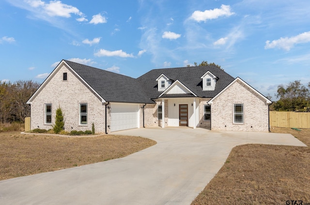 view of front of property with a garage and a front yard