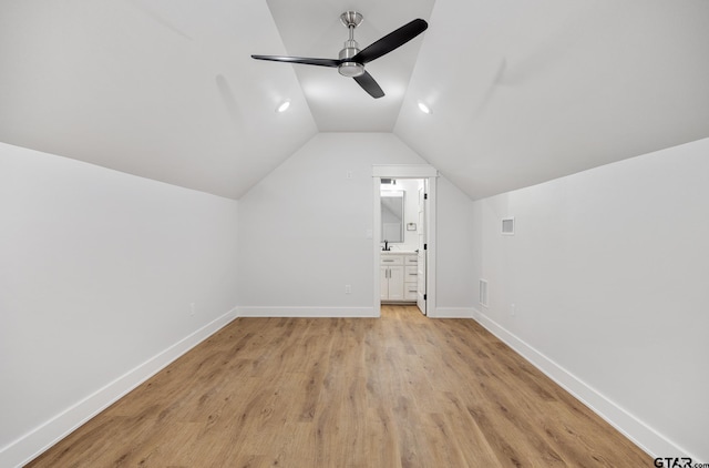 additional living space featuring light wood-type flooring, ceiling fan, and vaulted ceiling