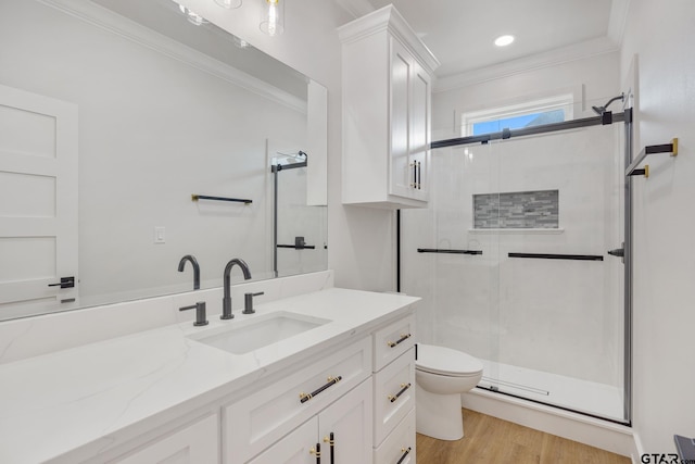 bathroom featuring toilet, hardwood / wood-style flooring, an enclosed shower, vanity, and crown molding