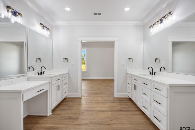 bathroom featuring vanity, hardwood / wood-style flooring, and ornamental molding