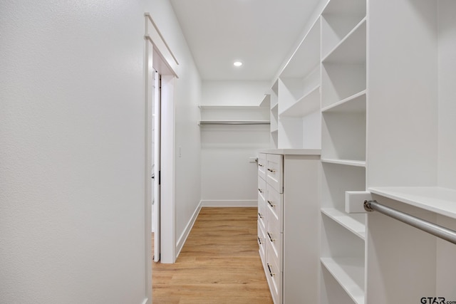 spacious closet with light hardwood / wood-style floors