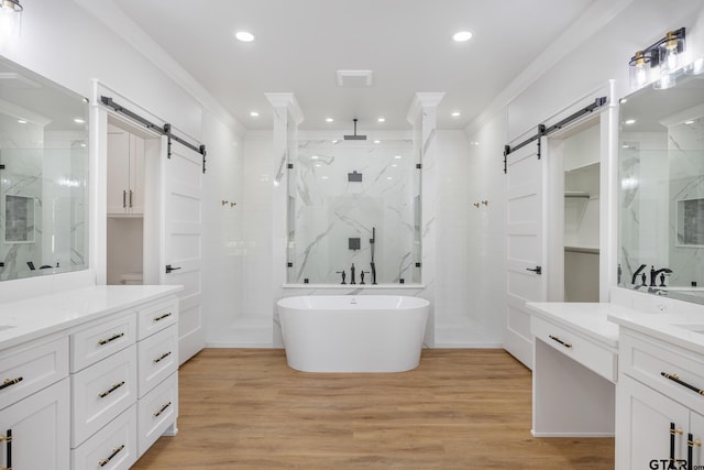 bathroom with independent shower and bath, hardwood / wood-style floors, and ornamental molding