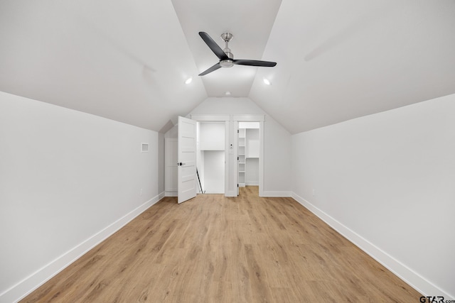 additional living space featuring light wood-type flooring, ceiling fan, and vaulted ceiling